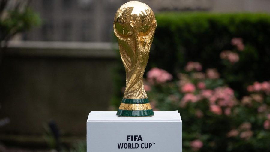 The 2022 World Cup Trophy sitting on the podium in Doha