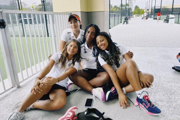 Sasha Kilgour, Leyla Kilgour, Emma Grassbaugh, and Miranda Blanco posing by the tennis courts