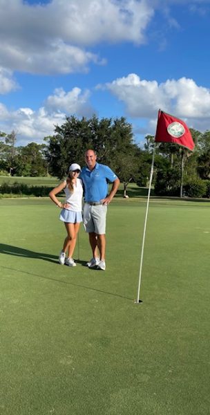 Danica Ortega poses on the green with her coach after making a birdie. 