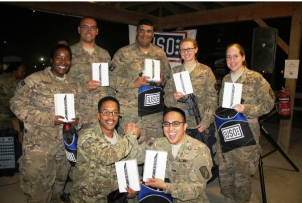 Seven soldiers receive iPads from the iPads for Soldiers organization.