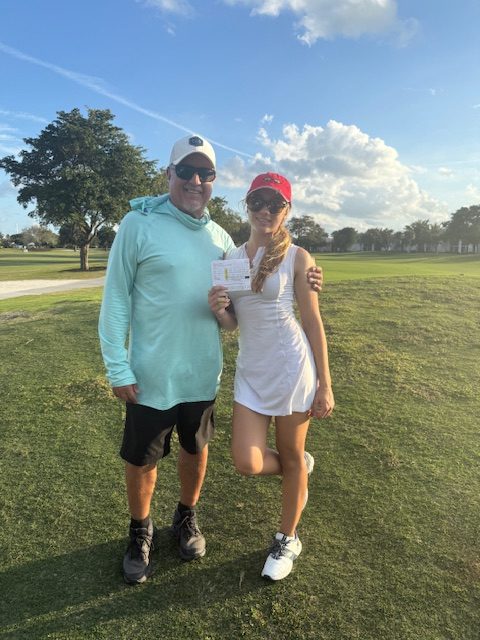 Danica and her father after winning a golf match.