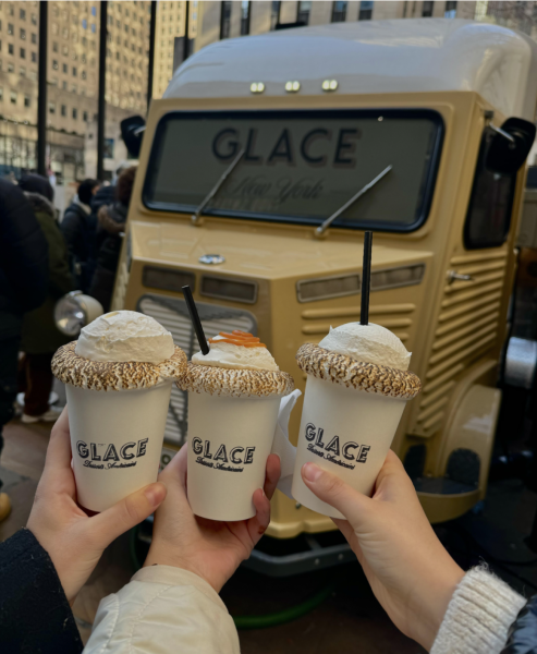 Glace's signature hot cocoa flavors are shown in front of its famous mini bus.