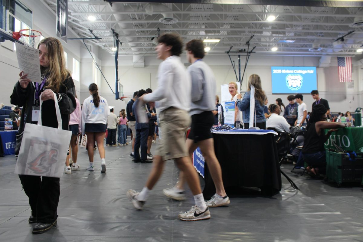 Students explore booths at the college fair on Oct. 3, 2025, in the school gym, gathering information from visiting universities and programs. The room buzzes with energy as representatives hand out brochures and free merchandise. 