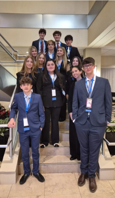 All 14 Riviera DECA members who won districts and qualified for States. Taken before the kickoff event, pictured in full DECA business attire reflecting the core values and business principles of the organization. 